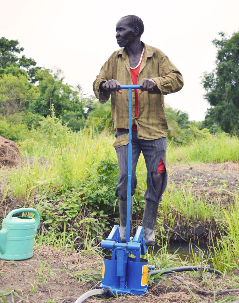 Sudanese smallholder farmer Moses irrigates his vegetable plot, where reliable irrigation now allows him to grow and sell produce beyond the rainy season.